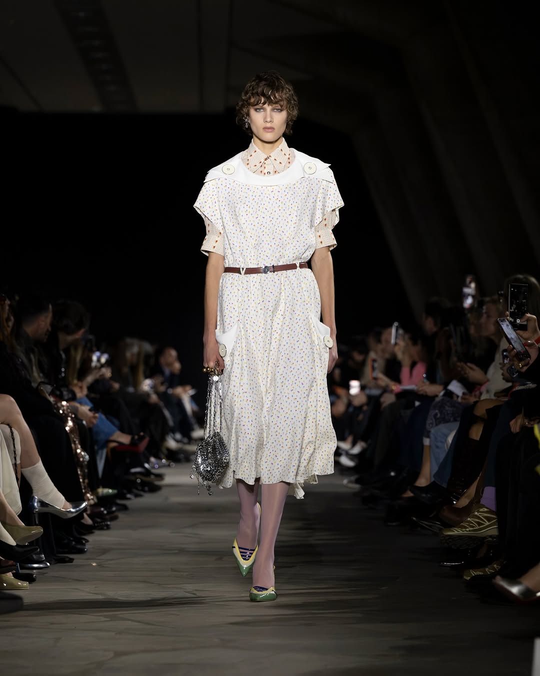 The Rabanne Fall/Winter 2026 ready-to-wear lineup featured a belted polka-dot midi dress paired with a short-sleeved polka-dot turtleneck top underneath.