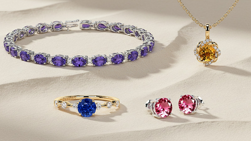 sapphire ring, pink tourmaline earrings, citrine pendant, and tanzanite bracelet