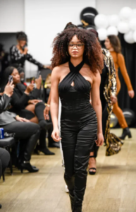 Model on the runway in black outfit
