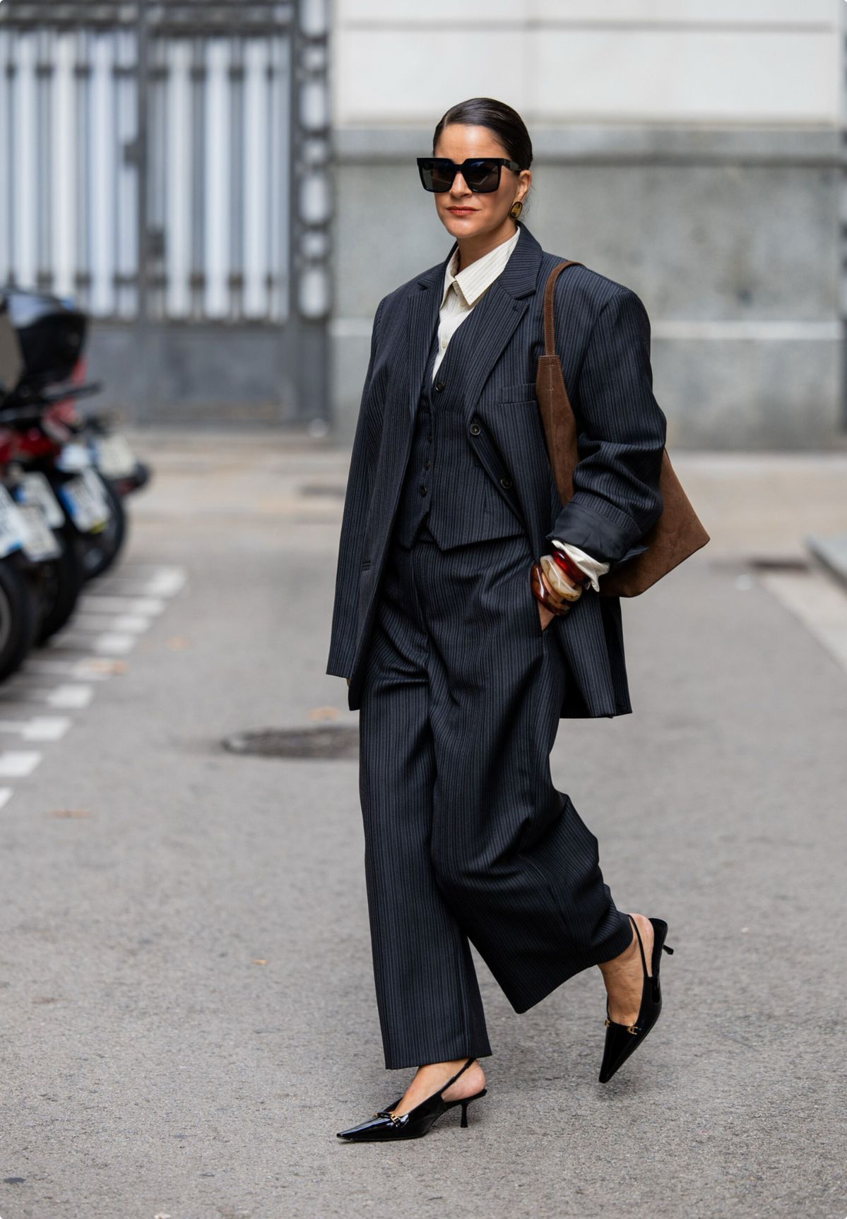a woman in corporate attire and paired it with black basic heels