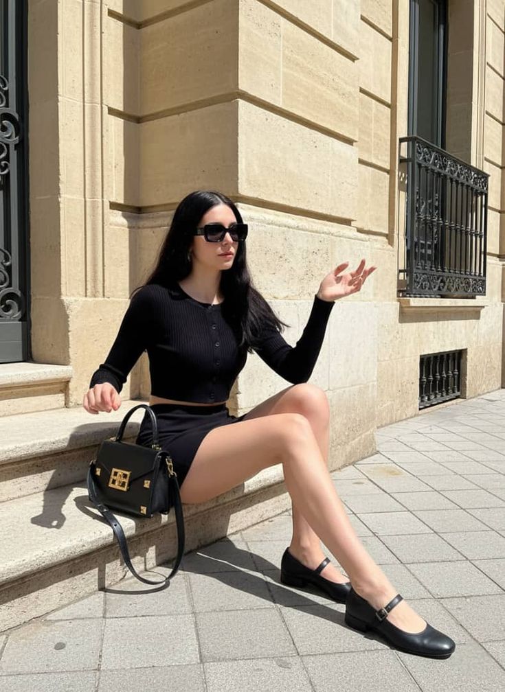 a woman is wearing a black Ballet Flats