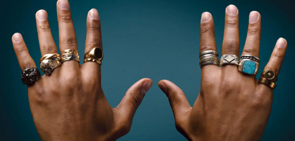 two hands wearing rings and sterling silver rings 