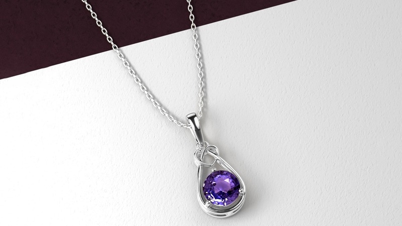 Silver chain necklace with a teardrop pendant holding a purple gemstone (amethyst).