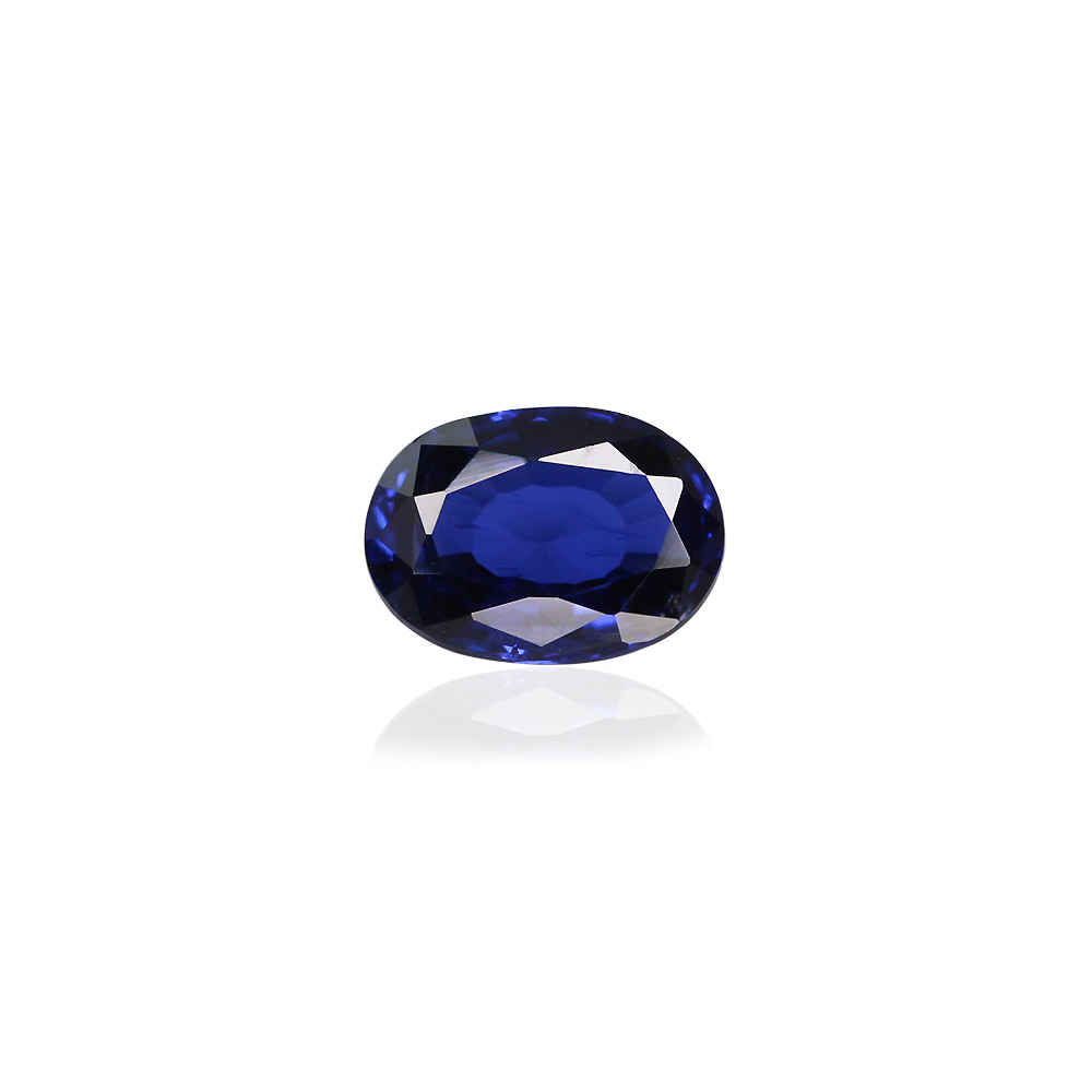 Oval blue sapphire-like gemstone with deep blue color and faceted surfaces