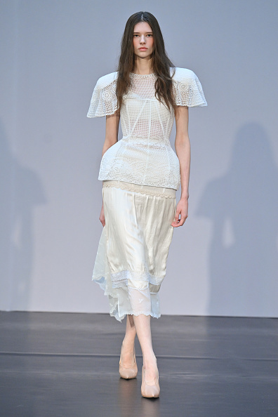 The Magda Butrym Womenswear Spring/Summer 2026 ready-to-wear show, titled “The Studio,” showcased a white short-sleeve cape crochet midi dress