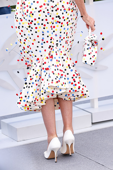 ‎Demi Moore attended the 2026 Cannes Film Festival at the Palais des Festivals wearing a Jacquemus strapless flared midi dress and a bag from the Fall/Winter 2026 “Le Palmier” collection, adorned with red, yellow, blue, green, orange, and pink polka dots.