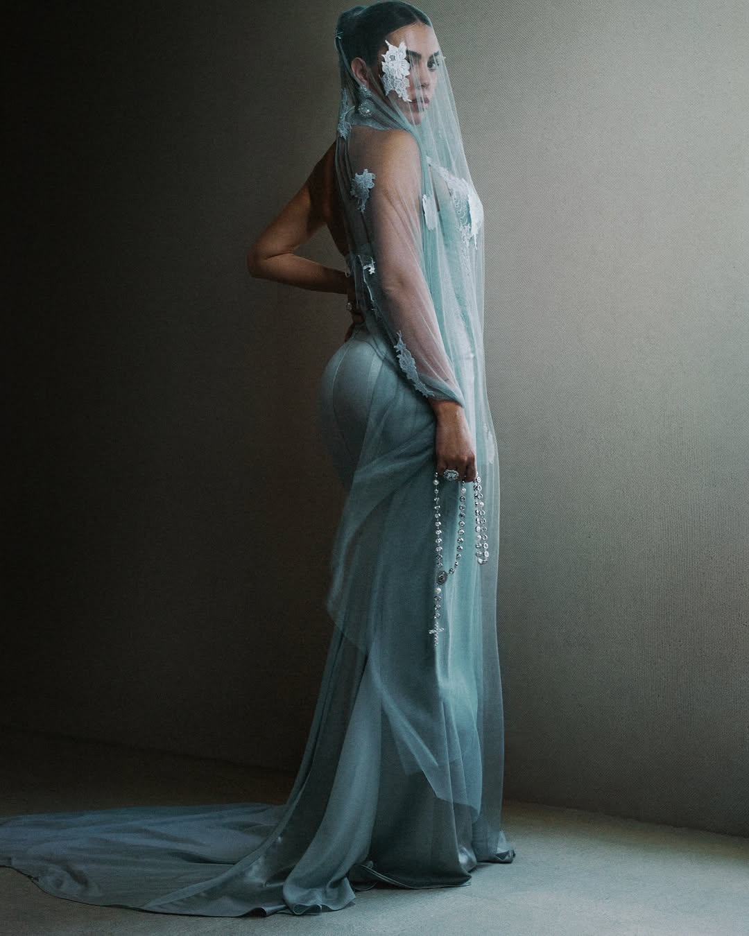 At the 2026 Met Gala, Georgina Rodríguez looked fantastic in a personalized Ludovic de Saint Sernin mesh veil with white hand-embroidered lace flowers, a corseted lace-up gown, and a white gold rosary adorned with diamonds and pearls.