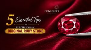 Navratan advertisement: '5 Essential Tips for Purchasing an Original Ruby Stone' with a ruby held by tweezers on red velvet.