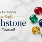 Hero banner with the title 'How to Choose the Right Birthstone for Yourself' and a cluster of colorful gems on a marble surface.