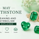 Graphic about May birthstone meaning and symbolism, featuring a gold ring with emeralds and green gems on a light background.