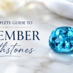 Promotional banner: 'The Complete Guide to December Birthstones' with blue and purple gemstones on a marble surface.