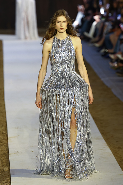 A model strutted down the runway in the silver metallic “Tinsel Lattice” fringe gown during Stella McCartney’s Womenswear Fall/Winter 2026–2027 ready-to-wear show.