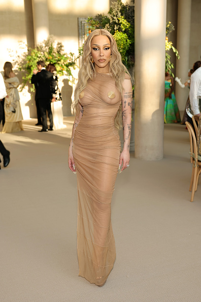 Doja Cat attended the Met Gala on Monday, May 4, 2026, wearing a Saint Laurent short-sleeved mesh dress and Saint Laurent “Kika” leather platform mules.