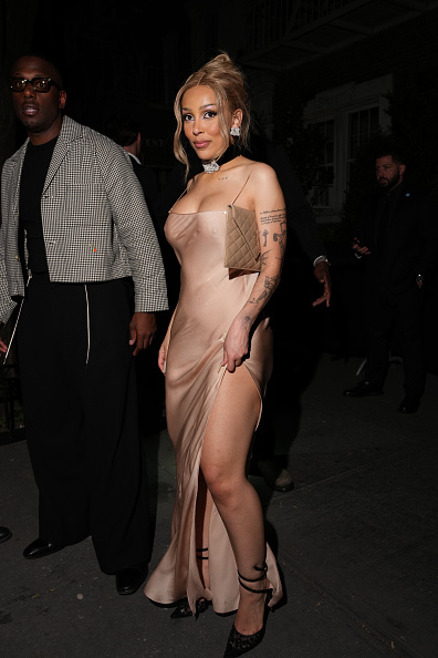 Doja Cat showed up at the 2026 Saint Laurent Met Gala afterparty in a custom, sleeveless Saint Laurent sheer silk slip maxi dress featuring a thigh-high slit, paired with René Caovilla “Allura” lace-up pumps.