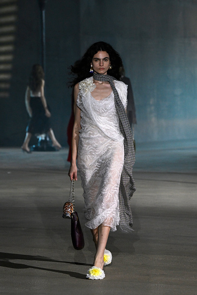 Dior’s 2027 Cruise collection featured a white draped lace slip midi dress, also worn by Sabrina Carpenter in the brand’s Haute Couture Fall/Winter 2026–2027 ready-to-wear show.