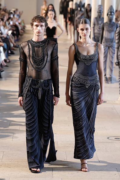 Rahul Mishra’s Haute Couture Fall/Winter 2026/2027 collection, “Devi: The Eternal Muse,” featured a draped grey sleeveless embroidered midi dress—a standout look worn by Isha Ambani in the front row.
