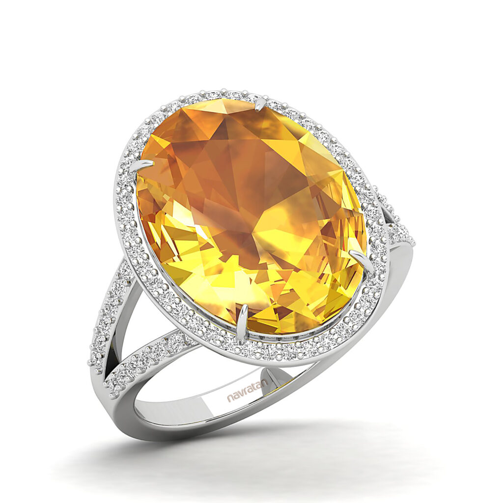Oval-cut Yellow Sapphire gemstone ring with a diamond halo set in white metal