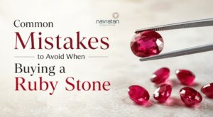 Banner about common mistakes to avoid when buying a ruby stone, with red gemstones being held by tweezers on the right.