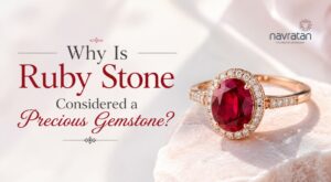Advertisement showing a rose-gold ruby ring with a diamond halo on a pale pink background, with the text 'Why Is Ruby Stone Considered a Precious Gemstone?'