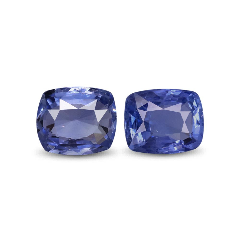 Two cushion-cut blue sapphire placed side by side on a white background.