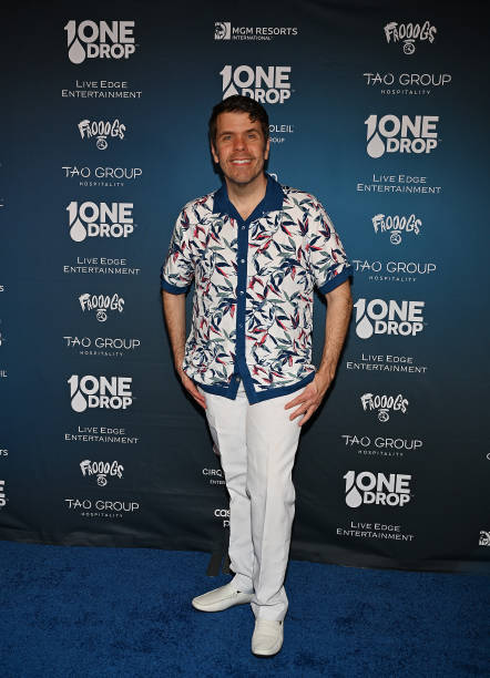 Perez Hilton was dressed in a Cubavera short-sleeve camp shirt with contrasting navy trim and a watercolor leaf motif.