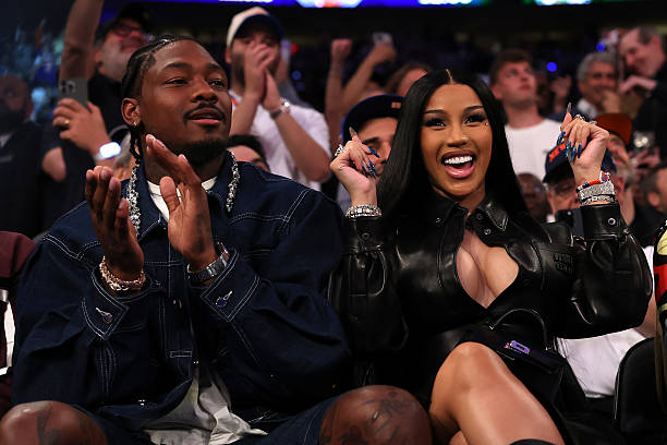 NFL player Stefon Diggs had a respectable appearance for the game by donning an enormous dark wash denim trucker jacket and accessorizing it with jewelry.