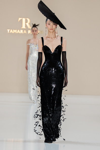 Tamara Ralph’s Spring/Summer 2026 Haute Couture collection, “La Lumière Dorée,” featured a black sequined column gown adorned with diamond coque feathers