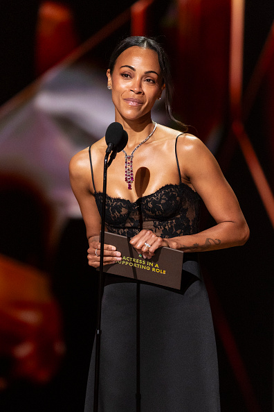 Zoe Saldaña looked stunning in a black Saint Laurent gown designed by Anthony Vaccarello.