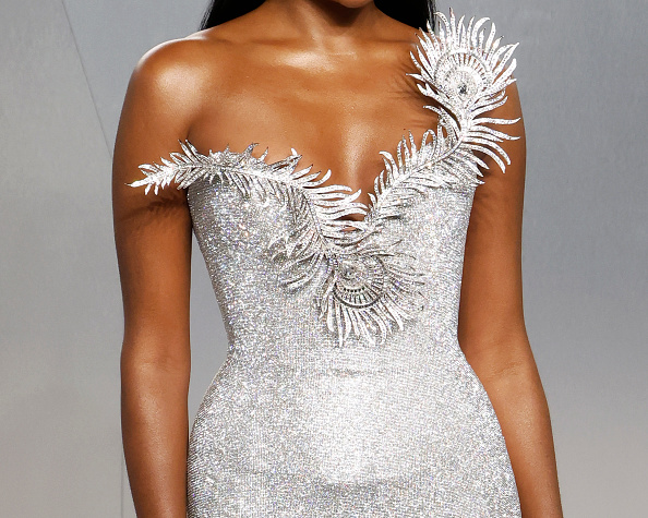 A closer look at Simone Ashley’s Tamara Ralph Haute Couture silver crystal-mesh column gown, worn to the 2026 Vanity Fair Oscar Party, featuring a sculptural peacock feather–inspired neckline.