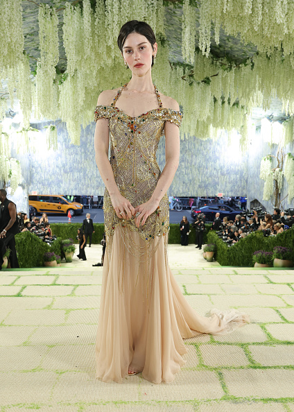 Gracie Abrams made a striking appearance on the 2026 Met Gala red carpet, wearing a chiffon gown by Chanel adorned with intricate gold embroidery.