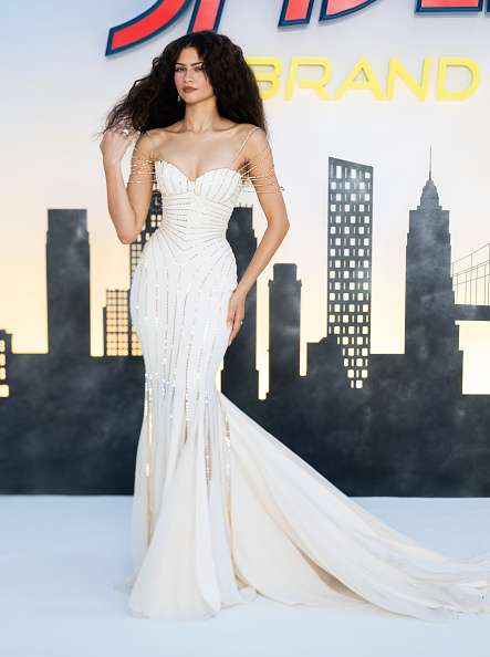 Zendaya attended the UK premiere of “Spider-Man: Brand New Day” wearing a Tamara Ralph Haute Couture silk mermaid gown embellished with crystals and complemented by gold baguette-chain straps.