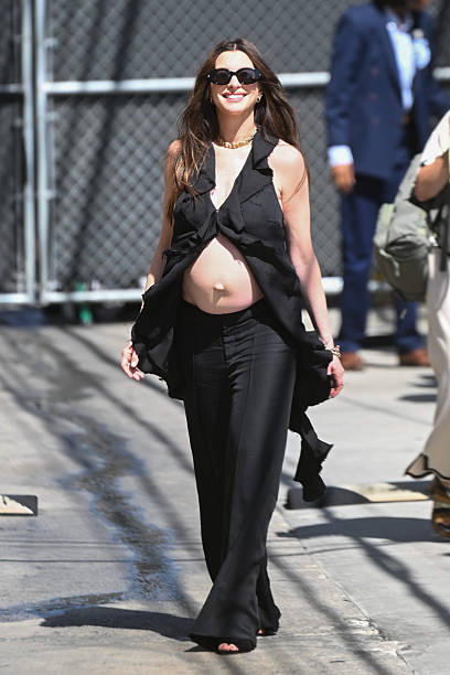 Anne Hathaway attended “Jimmy Kimmel Live” dressed beautifully in a plunging, ruffled black blouse and low-rise trousers.