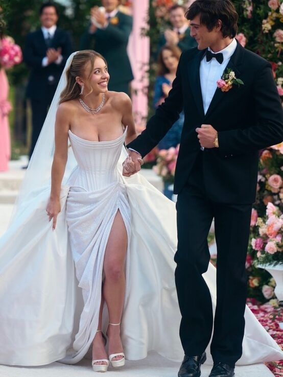 Sydney Sweeney in an off-the-shoulder Wiederhoeft wedding gown.