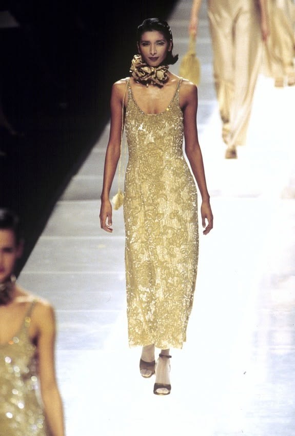 Giorgio Armani’s Fall/Winter 1995 collection featured a gold-embroidered, beaded, sequined scoop-neck slip maxi dress, later reimagined for Kendall Jenner at the 83rd Venice Film Festival premiere of “Wild Horse Nine.”