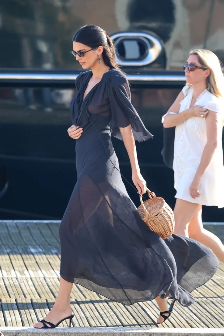 Kendall Jenner attended the second day of the 2026 Venice International Film Festival wearing a Vivienne Westwood Priscilla gown made from silk and wool-blend jacquard muslin, styled with vintage Manolo Blahnik sandals, a Maison Ola “Le Jane” wicker bag, and Alexander Calder 1955 earrings.
