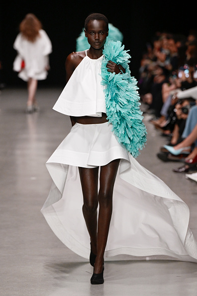 Yar Aguer walked the runway at Stella McCartney’s Spring/Summer 2026 show in a white two-piece look comprising a sleeveless cotton-poplin top and coordinating high-low miniskirt