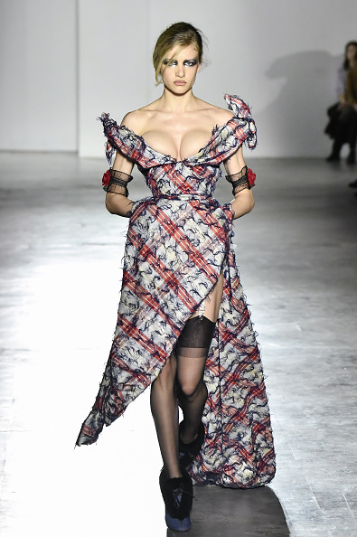 Andreas Kronthaler’s Vivienne Westwood Fall/Winter 2026–2027 collection featured a plaid corseted dress with a thigh-high slit and off-the-shoulder bow detail