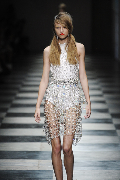 Miuccia Prada’s Spring/Summer 2010 collection featured a crystal chandelier mini dress, crafted from an intricate sheer mesh of crystal beads joined by silver hardware
