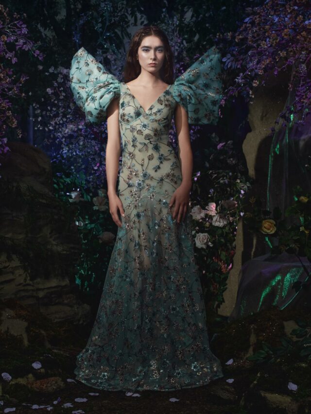 Rodarte’s Spring/Summer 2026 ready-to-wear collection featured a floral-embroidered gown in shimmering tulle, defined by a plunging V-neckline and exaggerated cap sleeves that lifted into sharp points, forming a dramatic, wing-like silhouette