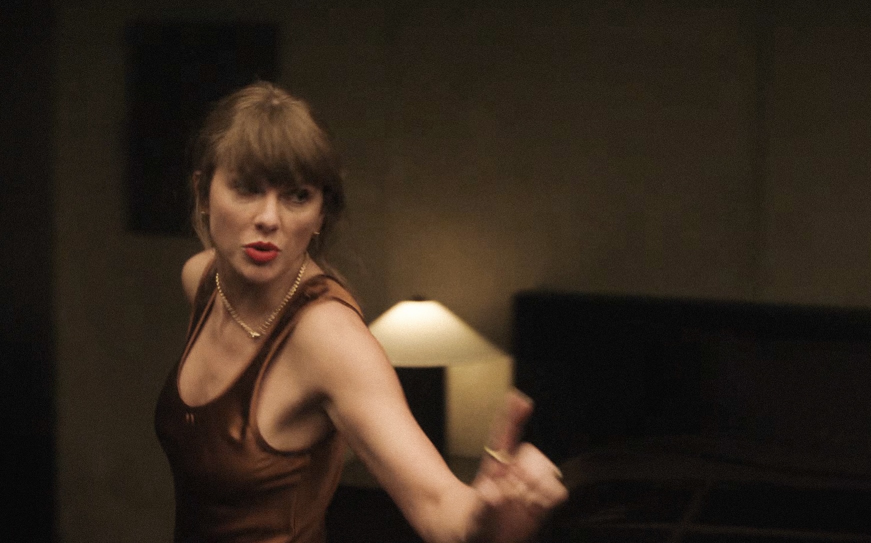 Taylor Swift was captured on the set of the “Patient Zero” music video in Heirlome’s “Margot” scoop-neck silk-satin maxi dress, paired with Jenna Blake’s box chain featuring a diamond clasp.
