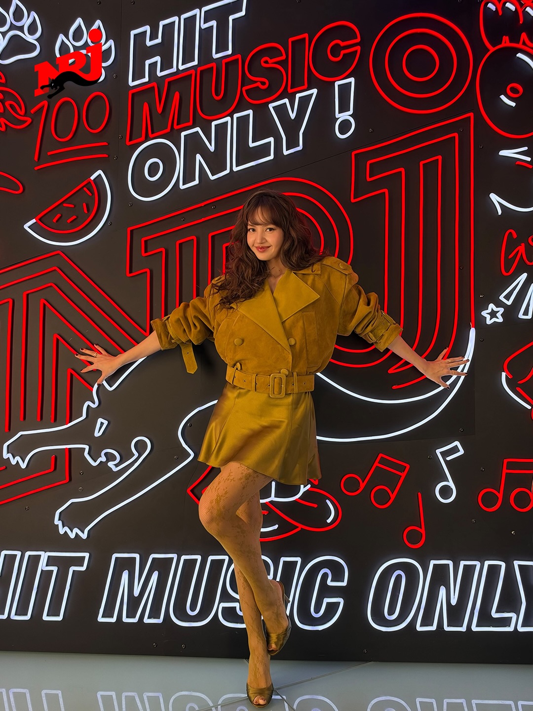 BLACKPINK Lisa was seen at NRJ Radio Studio during Paris Spring/Summer 2027 Fashion Week, wearing a head-to-toe Retrofête look featuring the ochre Rubee cropped suede trench coat over the matching Bonny sheer Chantilly lace A-line mini dress, completed with Alejandra ochre silk mules.