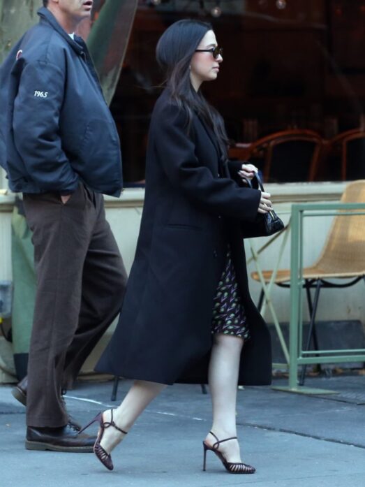 Mikey Madison looked polished during the New York City press tour for “The Social Reckoning,” pairing a double-breasted midi coat with a vintage-inspired Miu Miu silk slip dress in a tulip floral print and finishing the look with Aquazzura satin “Sweet Surrender” strappy pumps.