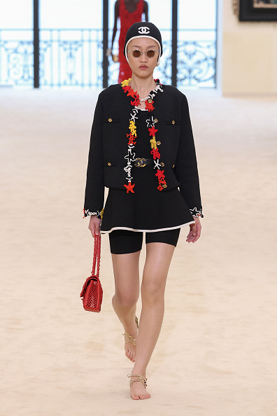 At Chanel’s 2026/2027 Cruise show, Chinese model Feng Jiao Long graced the runway in a polished black tweed jacket worn over a tiny two-tone black-and-white dress.