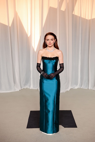 Joey King attended the sixth annual Academy Museum Gala at the Academy Museum of Motion Pictures on Saturday, October 17, 2026, wearing a custom two-tone Miu Miu gown crafted from dark teal duchesse faille satin and detailed with black crêpe, paired with sheer black tulle opera gloves and Bvlgari high jewelry.