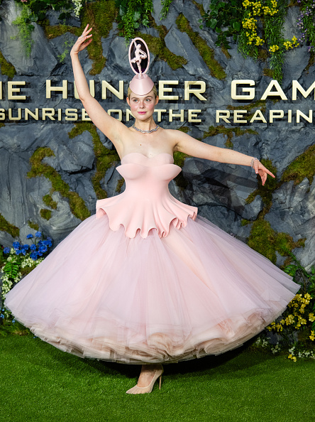 Actress Elle Fanning attended the London premiere of “The Hunger Games: Sunrise on the Reaping” wearing a ballet-inspired couture strapless lace-up tutu gown, paired with a pillbox fascinator adapted from Look 19, originally modeled by Ombeline Suroy on the runway during Robert Wun’s “Childsplay” ready-to-wear collection.